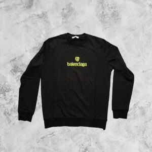 BALENCIAGA LONG SLEEVE TOP IN BLACK WITH YELLOW LOGO FRONT